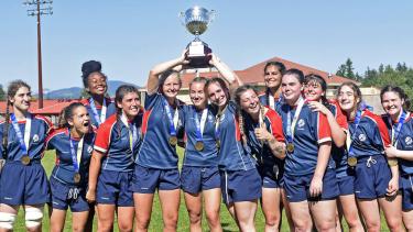 Yale Senior AAA Girls Rugby June 2023 Senior Girls Rugby Team pose for photo holding trophy above their heads (Photo credit: John Morrow/Abbotsford News)