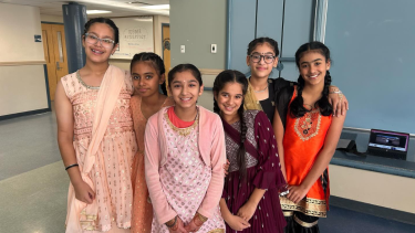 Group of female middle school students in traditional attire celebrating Diwali